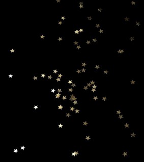 Punched small metallic stars falling in front of black back