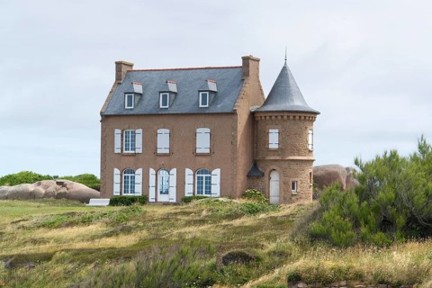 House and granite boulders around Perros-Guirec at the Pink Granite Coast in Brittany, France