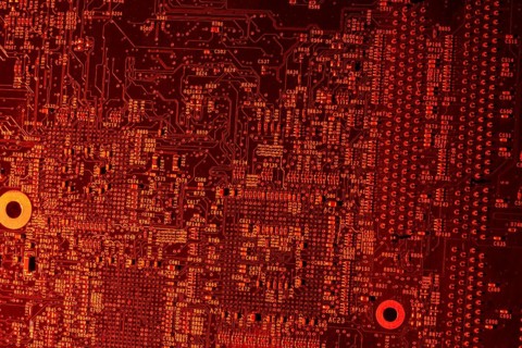 Full frame red illuminated printed circuit board closeup