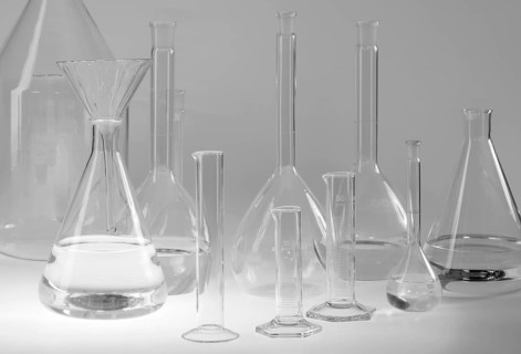 Variety of partly filled laboratory glassware