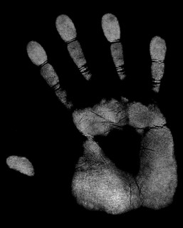 A white handprint of a right hand in black back