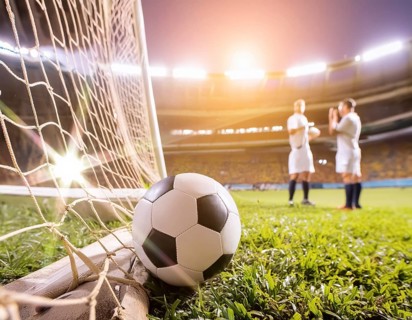 AI generated image showing a goal netting closeup and football in stadium ambiance