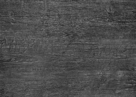 A full frame dark burnt wood grain surface