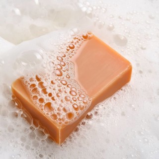 AI generated closeup image showing a soap bar and foam