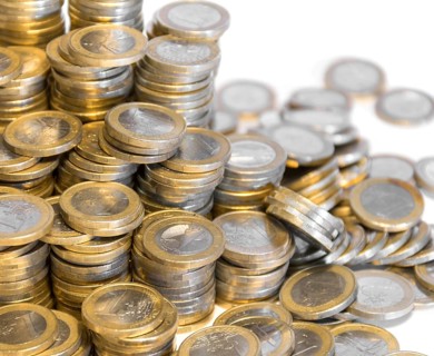 Lots of stacked 1 euro coins