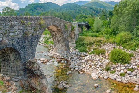 Historic stone bridge at the Ardeche river in southern France