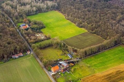 Aerial view nature friends hut Zum Eisernen Gustav with field at the edge of the Geithe forest in