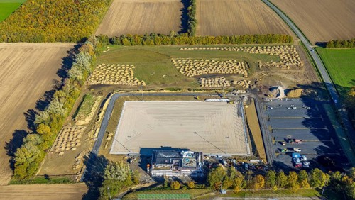 Aerial view, construction site and new sports field with stands and a club building with sports day