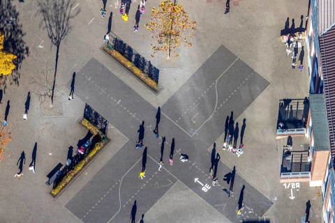 Aerial view, Overbergschule and pupils and cross on the schoolyard in the district Bockum-Hövel in