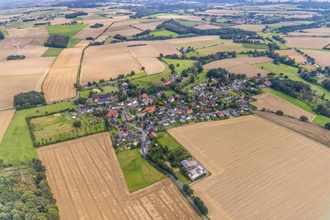 Aerial view, village view with protestant village church at the cemetery and catholic church St.