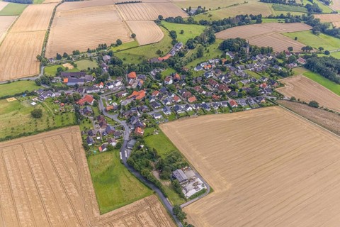 Aerial view, village view with protestant village church at the cemetery and catholic church St.