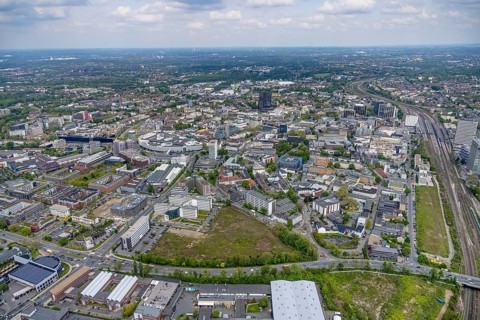Aerial view, brownfield Schwanenkampstraße, construction site and new office building at the corner