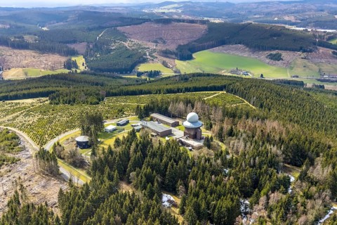 Aerial view, forest damage in a restricted military area, radar dome and radar station on Mount