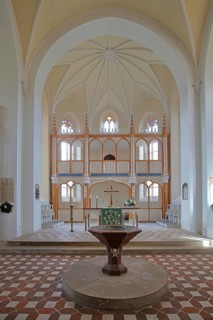 Baptismal font and chancel, interior view of the neo-Gothic St Peter's Church, UNESCO,