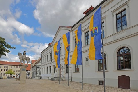 Town flags on the town hall with Roland statue, equestrian statue, equestrian statue, market
