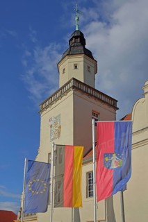 Renaissance town hall with EU flag, German national flag and town flag, three, flags, sundial, wall