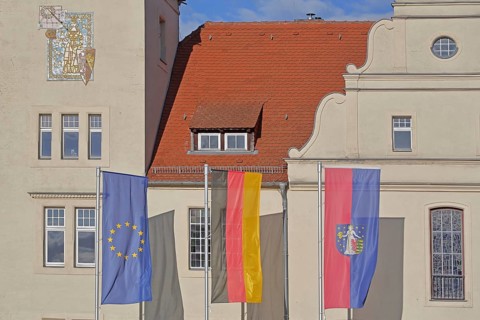 Renaissance town hall with EU flag, German national flag and town flag, three, flags, Coswig,