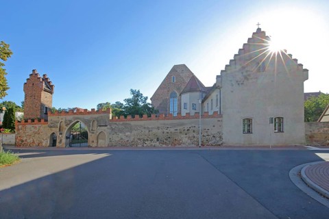 Francisceum built 13th century in backlight, former Franciscan monastery, tower with battlements,