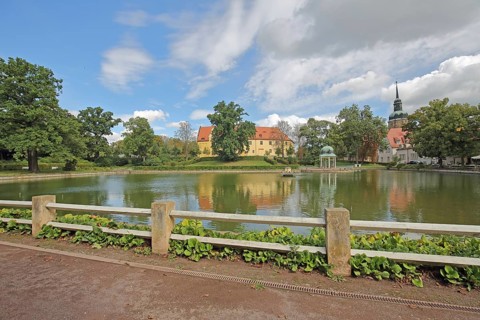 Castle and pavilion at the spa park pond with church tower of the town church, Goethe School,