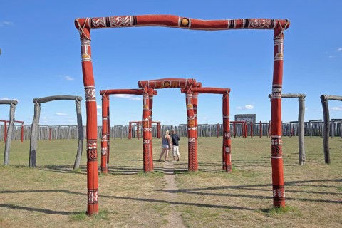 Archaeological reconstructed circular ditch from the Stone Age, Bronze Age, archway with visitors,