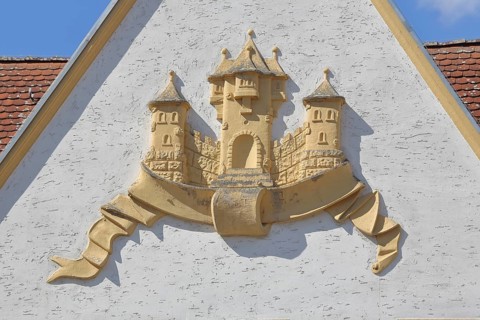 Town coat of arms in relief on the gable of the town hall, Barby, Saxony-Anhalt, Germany