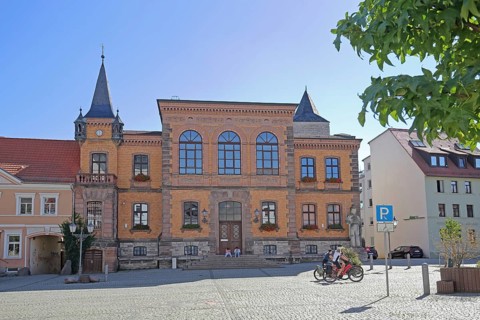 Town hall built in 1876, cyclist, market square, Calbe, Saxony-Anhalt, Germany
