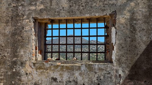 View through a barred window onto a mountain landscape, Old Silk Factory, German Wehrmacht military