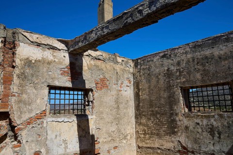 Interior view of a dilapidated building with rustic bricks and lattice windows, Old silk factory,