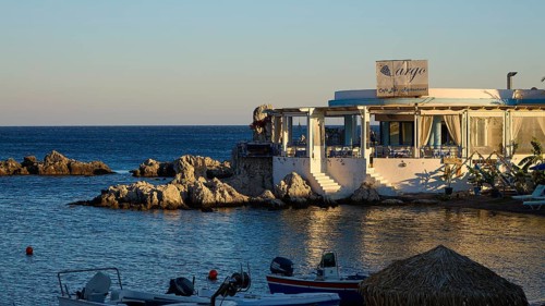 Restaurant Argo, evening mood at a restaurant with sea view and small boats in front of rocky