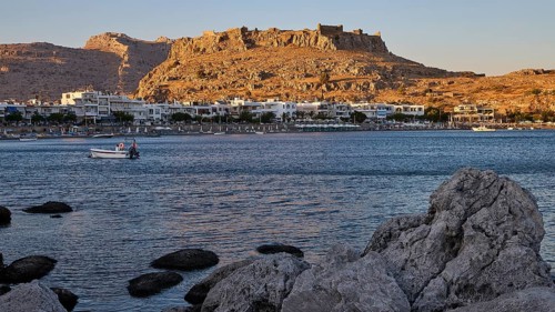 Feraklos fortress, coastal town with a castle above the evening sky and rocks on the shore, bay,