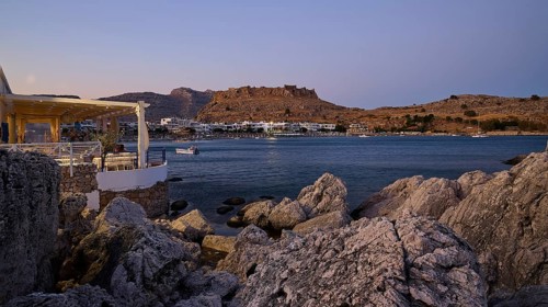 Restaurant Argo, Rock-framed view of a coastal town and sea at dusk, bay, Feraklos fortress,