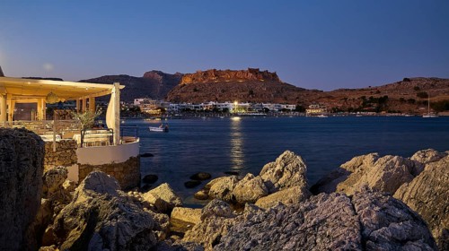 Argo restaurant, Feraklos fortress, night view of a castle above a quietly lit coastal town by the