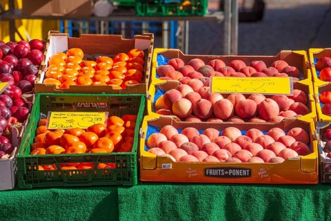 Necatarines and fresh fruit in crates with price tags on a market stall, Bremen, Germany