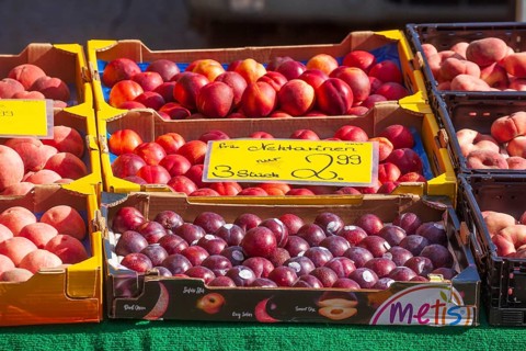 Necatarines and fresh fruit in crates with price tags on a market stall, Bremen, Germany