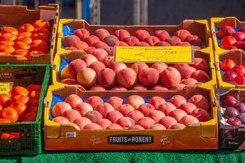 Necatarines and fresh fruit in crates with price tags on a market stall, Bremen, Germany