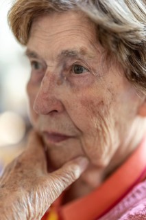 Close-up, authentic, unposed portrait of a 90+ year old senior woman with dementia and Alzheimer's