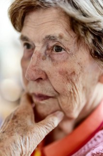 Close-up, authentic, unposed portrait of a 90+ year old senior woman with dementia and Alzheimer's