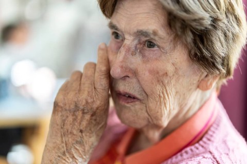 Close-up, authentic, unposed portrait of a 90+ year old senior woman with dementia and Alzheimer's