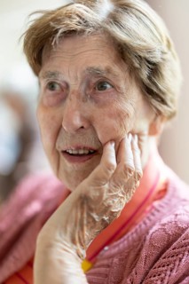 Close-up, authentic, unposed portrait of a 90+ year old senior woman with dementia and Alzheimer's