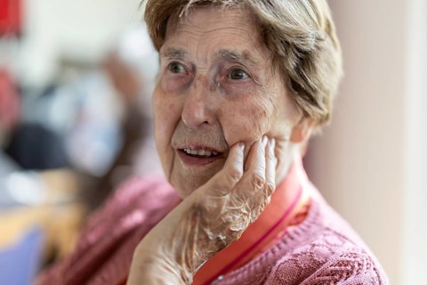 Close-up, authentic, unposed portrait of a 90+ year old senior woman with dementia and Alzheimer's