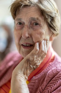Close-up, authentic, unposed portrait of a 90+ year old senior woman with dementia and Alzheimer's