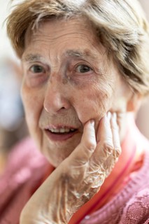 Close-up, authentic, unposed portrait of a 90+ year old senior woman with dementia and Alzheimer's