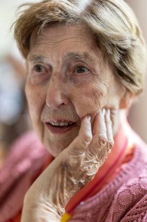 Close-up, authentic, unposed portrait of a 90+ year old senior woman with dementia and Alzheimer's