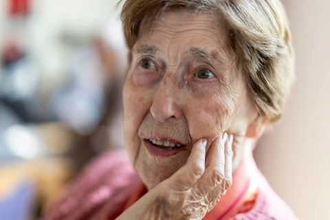 Close-up, authentic, unposed portrait of a 90+ year old senior woman with dementia and Alzheimer's