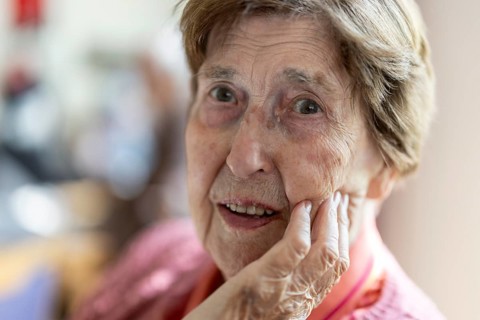 Close-up, authentic, unposed portrait of a 90+ year old senior woman with dementia and Alzheimer's
