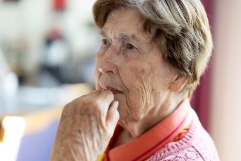 Close-up, authentic, unposed portrait of a 90+ year old senior woman with dementia and Alzheimer's