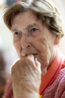 Close-up, authentic, unposed portrait of a 90+ year old senior woman with dementia and Alzheimer's