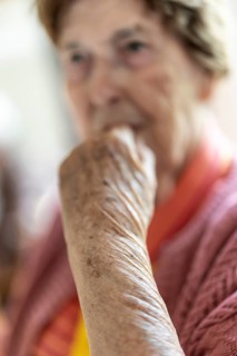 Close-up, authentic, unposed portrait of a 90+ year old senior woman with dementia and Alzheimer's