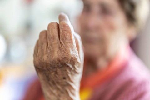 Over 90-year-old senior citizen with dementia talks and gesticulates with her wrinkled hands in a
