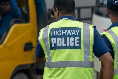 Highway police officer in a reflective vest directing traffic, Dhaka, Bangladesh